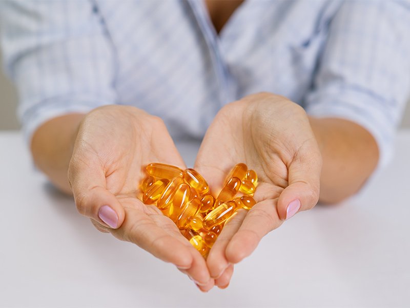 Life Extension, hands forming a heart holding omega-3 fish oil capsules